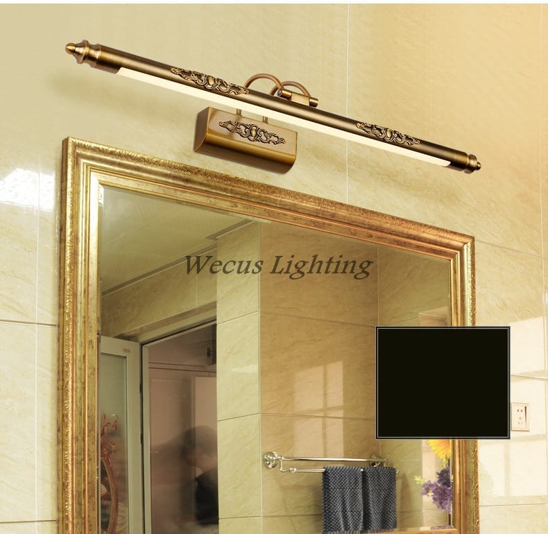 Antique bronze ornate led mirror lamp with brass finish and scrollwork detailing in a rectangular fixture housing for bathroom wall decor.