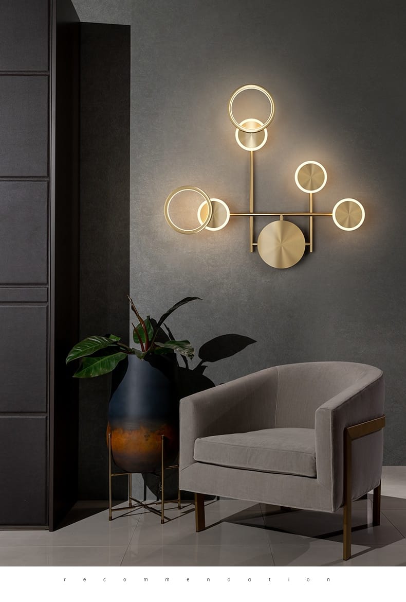 Modern golden geometric led wall lamp with a gold-toned circular design featuring glowing ring lights and a central disc, ideal for living room illumination.