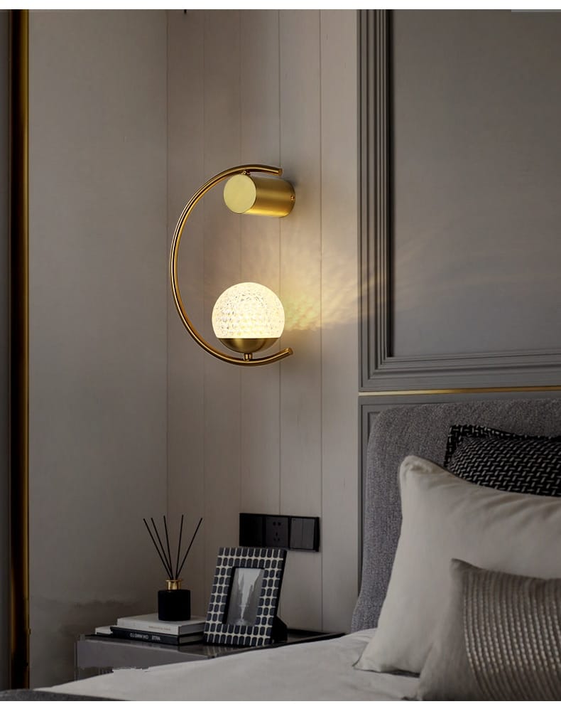 Modern gold luxury creative led crescent-shaped bedside wall sconce featuring a textured spherical globe and cylindrical accent for elegant bedroom lighting.