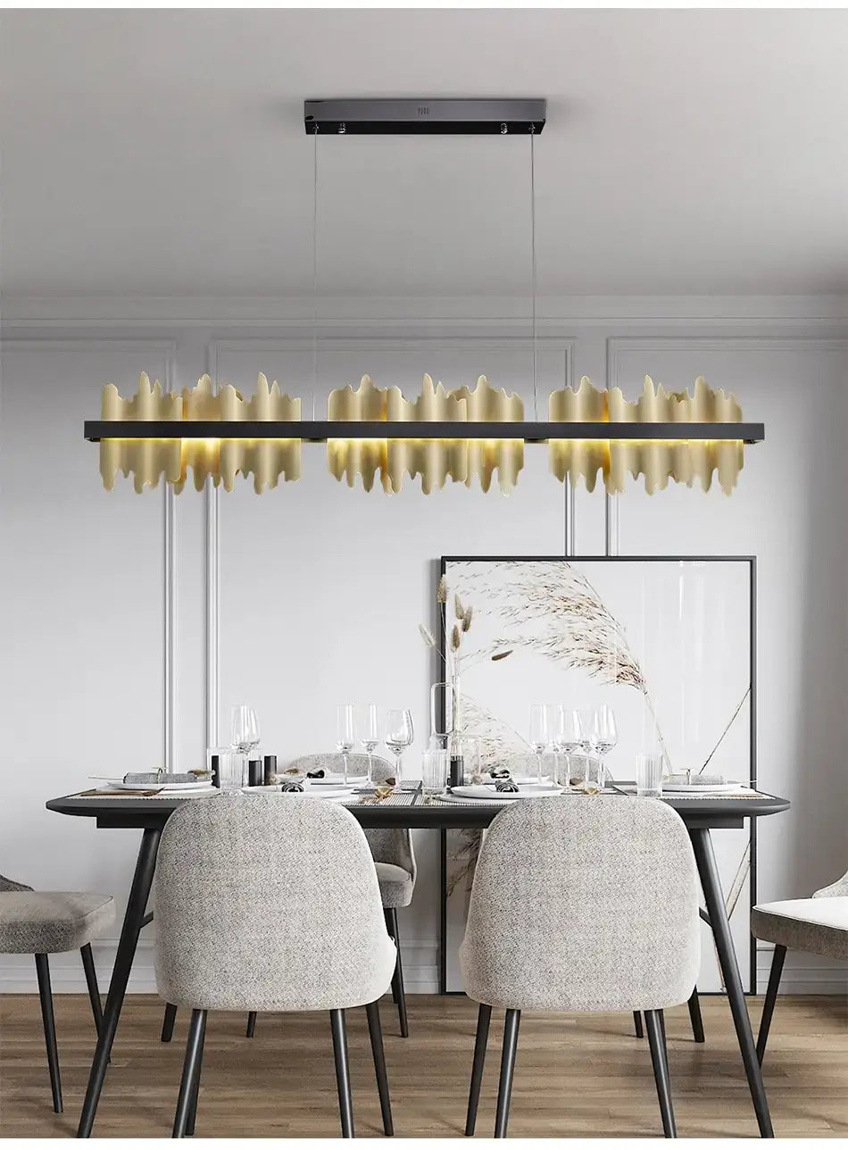 Modern gold and black iceberg led chandelier lighting features a gold-toned linear pendant light with a sleek black frame and textured wave-like glass elements ideal for dining room use.