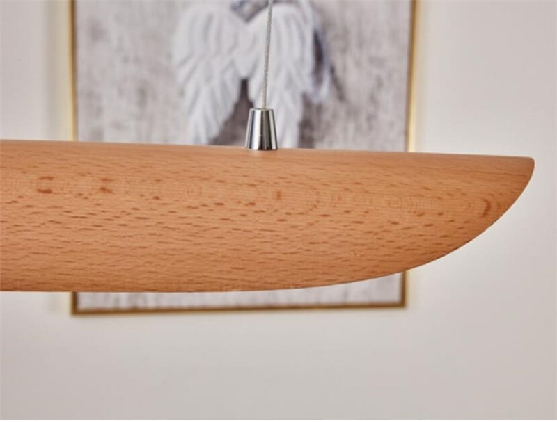 A sleek light brown wooden pendant lamp with a smooth curved design and metallic silver suspension fitting featured as a modern brushed gold kitchen island light fixture chandelier ideal for chandeliers kitchen island and wood chandeliers kitchen.