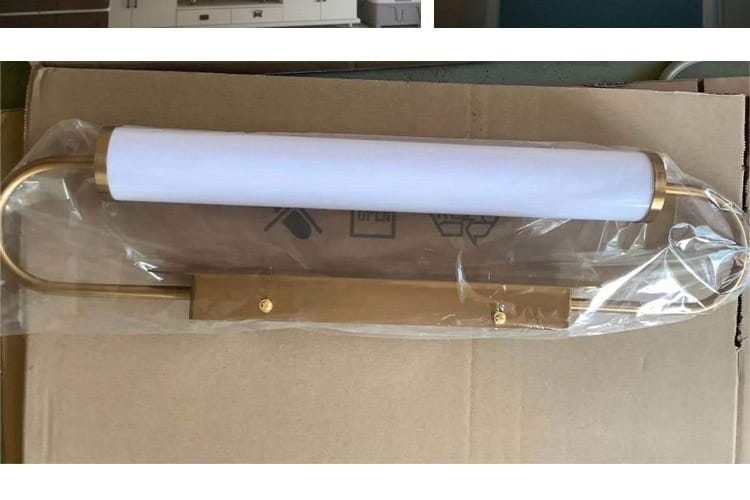 Modern minimalist gold led wall lamp with a cylindrical white frosted glass shade mounted on the wall, ideal as a bedroom cylindrical sconce.