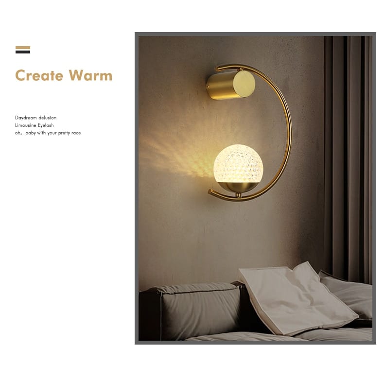 modern gold luxury creative led bedside wall lamp featuring a gold-toned curved arm and an illuminated textured spherical globe designed as a led bedside wall sconce for the bedroom.