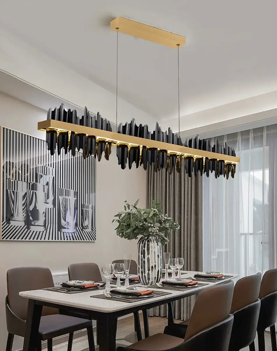 Modern gold and black iceberg led chandelier lighting features a sleek elongated rectangular frame with cascading cylindrical pendant elements designed for dining room use as led chandelier lighting.