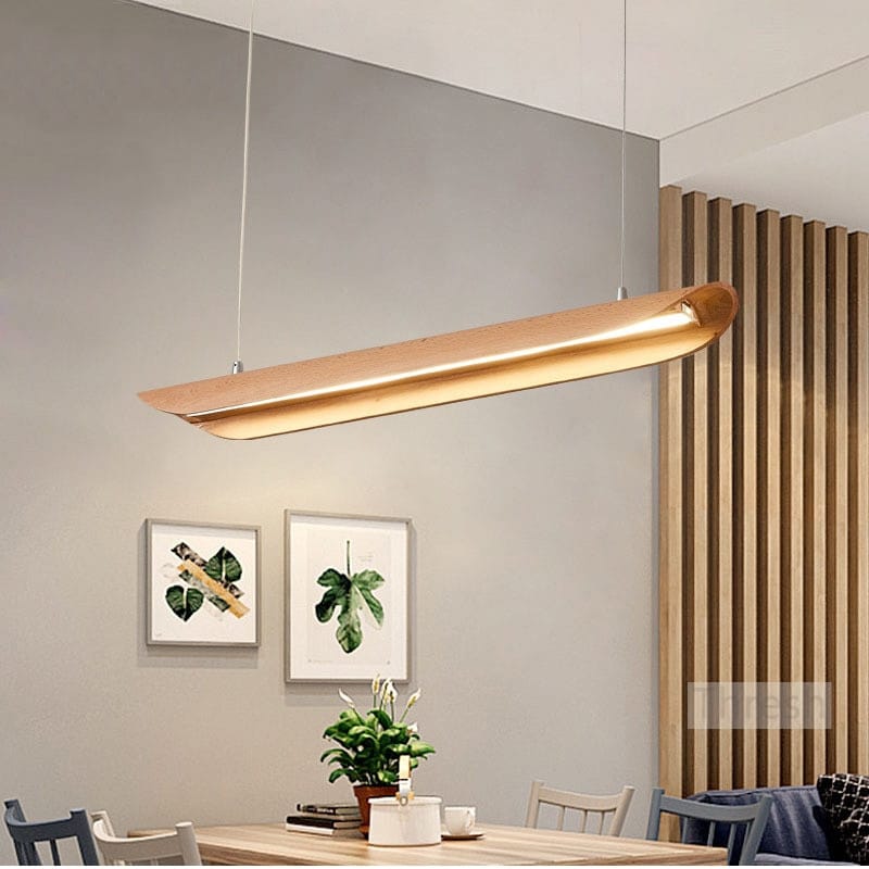 A sleek modern kitchen island light with a warm brushed gold finish and minimalist design hanging from the ceiling for use as chandeliers kitchen island or wood chandeliers kitchen.