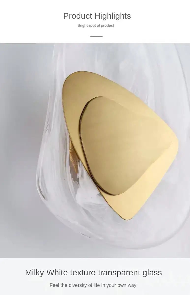 modern creative minimalist glass wall lamp featuring a gold-toned triangular-shaped glass coaster with a smooth reflective surface for bedroom bedside lighting