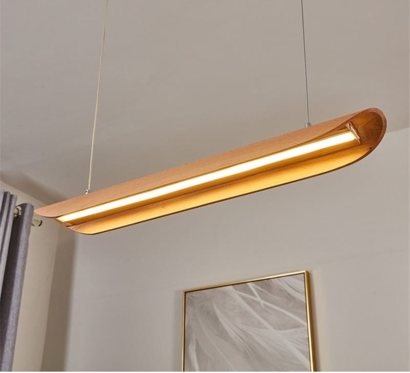 A sleek modern brushed gold kitchen island light fixture chandelier with a warm golden finish and curved rectangular design ideal for chandeliers kitchen island and kitchen island light decor.