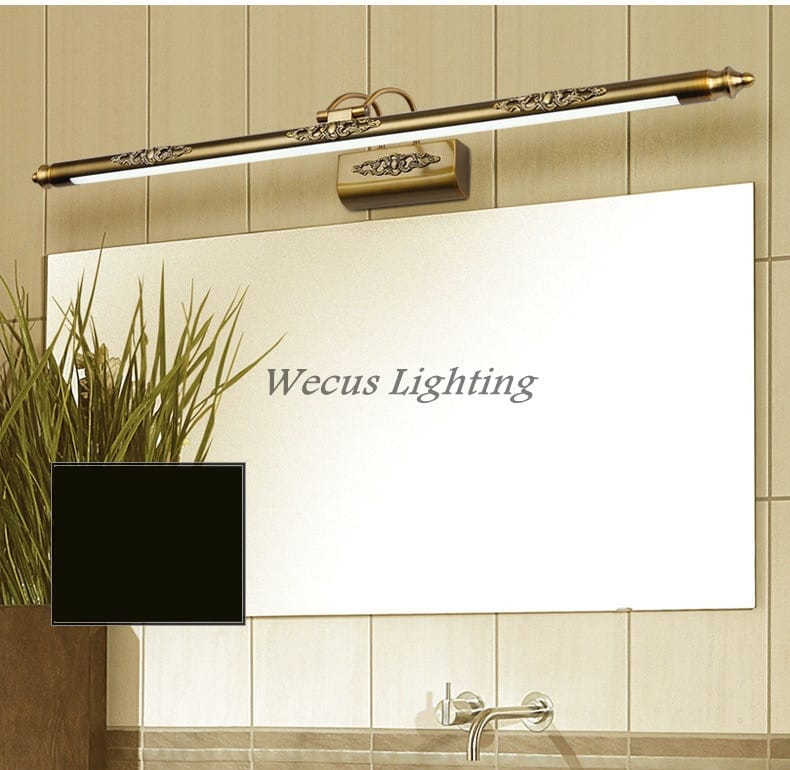 Antique bronze ornate led mirror lamp with an antique brass finish, floral detailing, and a sleek elongated design for bathroom wall decor.