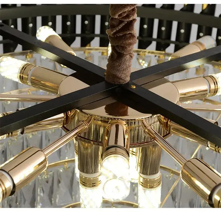 Luxury k9 crystal tiered chandelier in black and gold featuring gold-toned metal, crystal accents, and a textured brown fabric cord designed for dining room lighting from Nebra luxury crystal chandeliers.