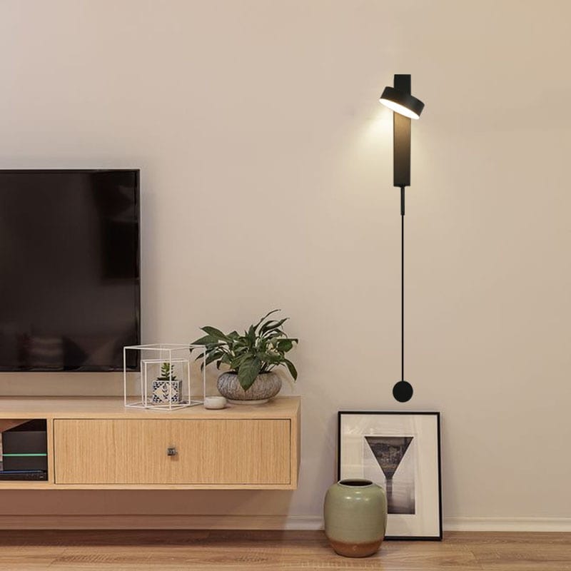 Black modern led wall lamp with a sleek minimalist design and adjustable rotating sconce light for bedroom use.