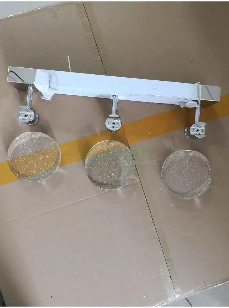 White rectangular led wall lamp with three adjustable spotlights featuring simple crystal led clear glass diffusers with embedded glitter, designed for modern bathroom lighting.