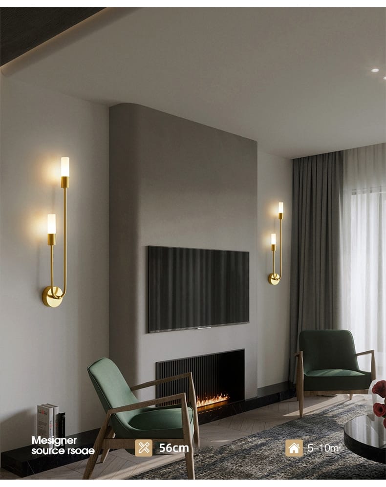 modern gold minimalist led wall lamp features gold-toned slender curved arms and cylindrical frosted glass shades as a vertical bedroom wall lamp.