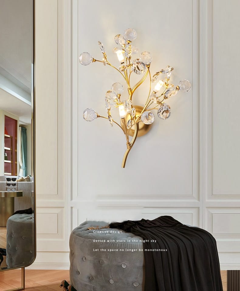 post modern luxury gold-toned wall sconce featuring crystal branches and spherical accents for modern luxury branch lighting in bedroom settings.
