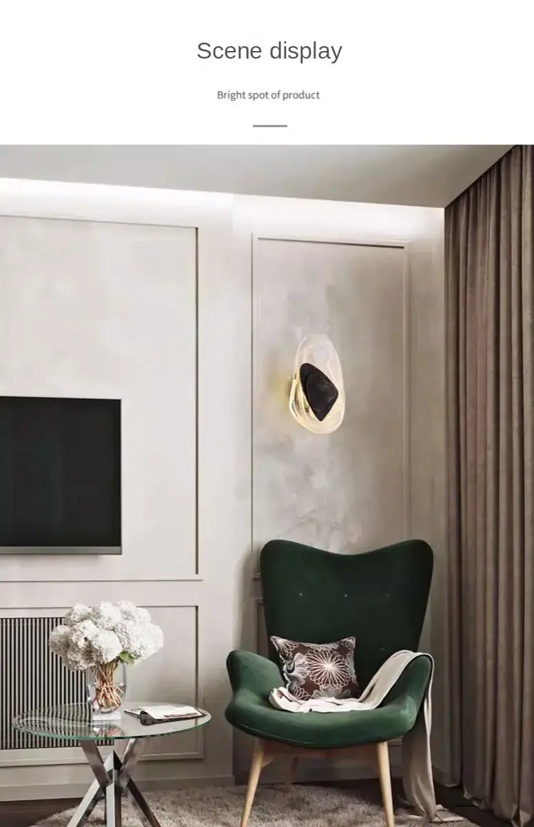 emerald green velvet armchair with wooden legs and patterned cushion next to a modern creative minimalist glass wall lamp for bedroom bedside lighting