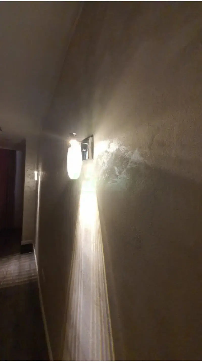 A modern gold crystal led wall lamp with a simple crystal led frosted glass shade and metallic frame designed for bathroom use.