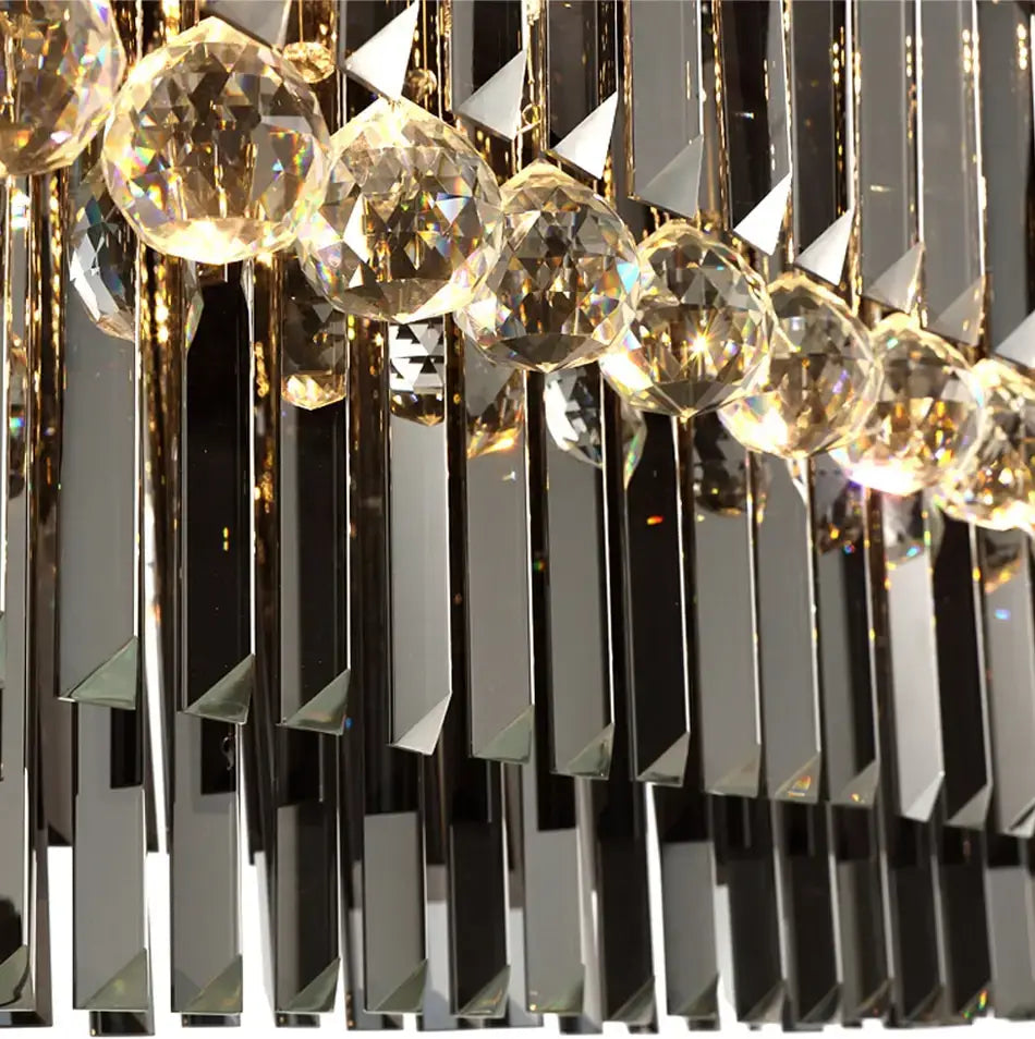 A modern black rectangle crystal chandelier featuring cascading rows of faceted crystal spheres and mirrored glass rods with gold-toned metal fittings, ideal for dining room hanging light.