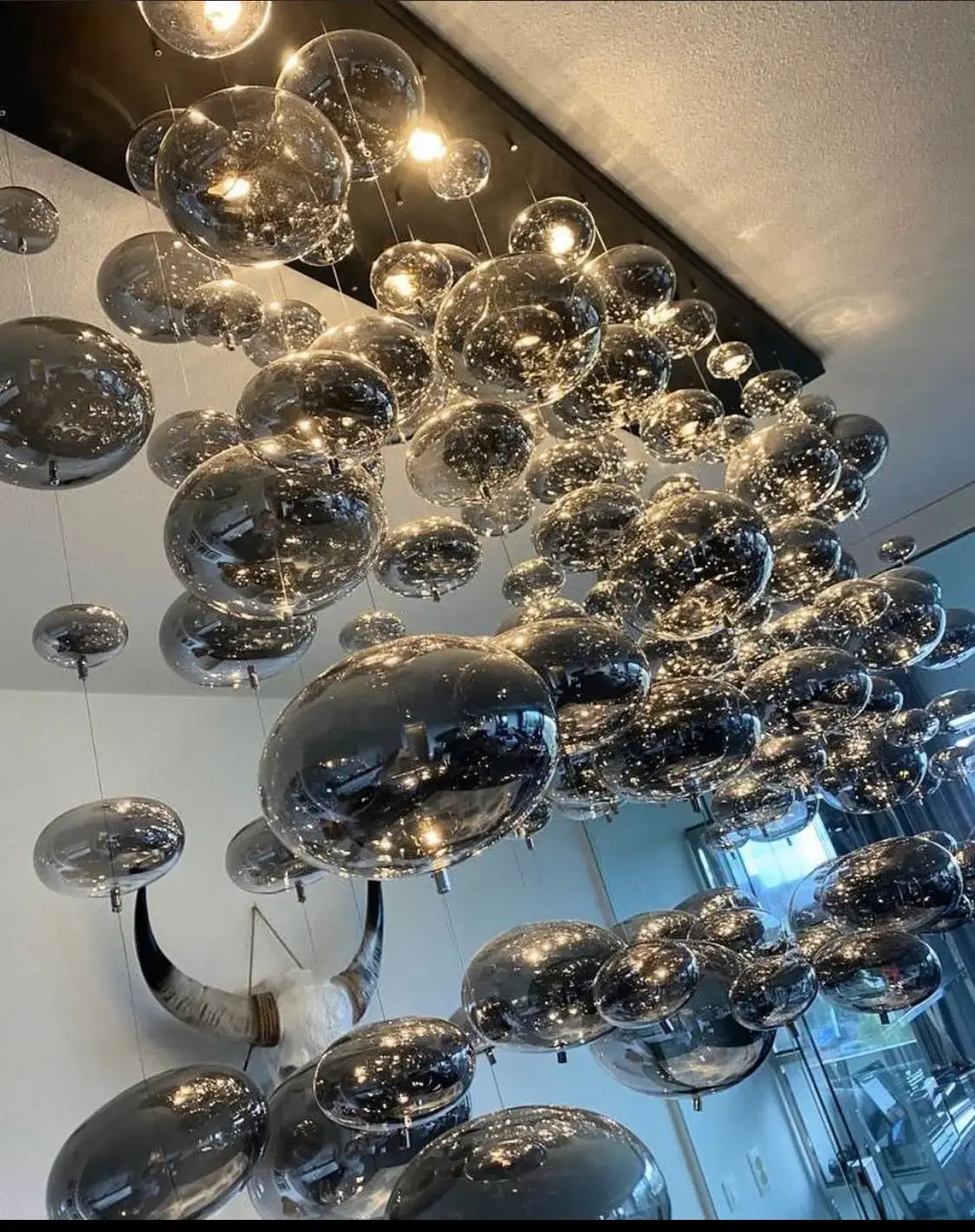 modern oval bubble ball silver chandelier featuring transparent reflective glass spheres suspended for dining room lighting fixture