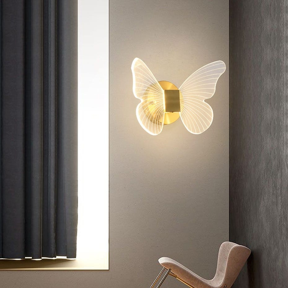 Art deco gold swan wall lamp with crystal features a gold-toned butterfly-shaped wall lamp with translucent ribbed wings emitting a soft glow, ideal for bedroom bedside use.