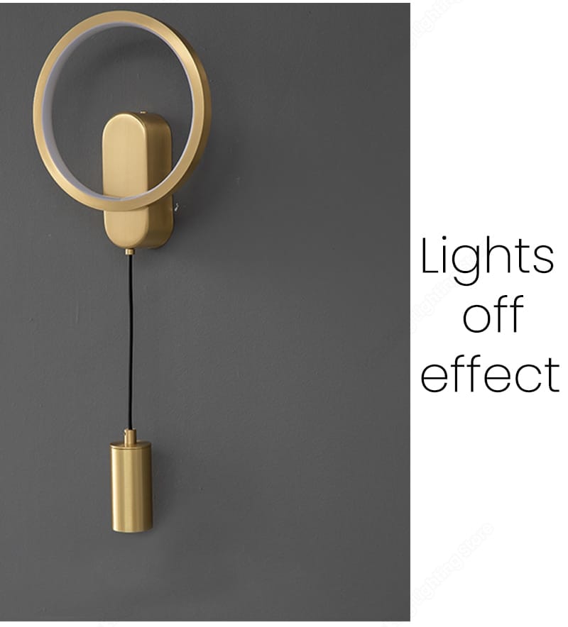 modern nordic led wall lamp featuring a gold-finished circular wall sconce with a cylindrical pendant hanging below by a black cord in black gold finish.