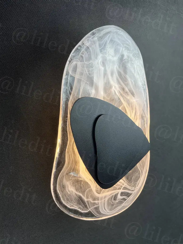 modern creative minimalist glass wall lamp featuring a transparent marbled inlay with a black triangular insert for bedroom bedside lighting