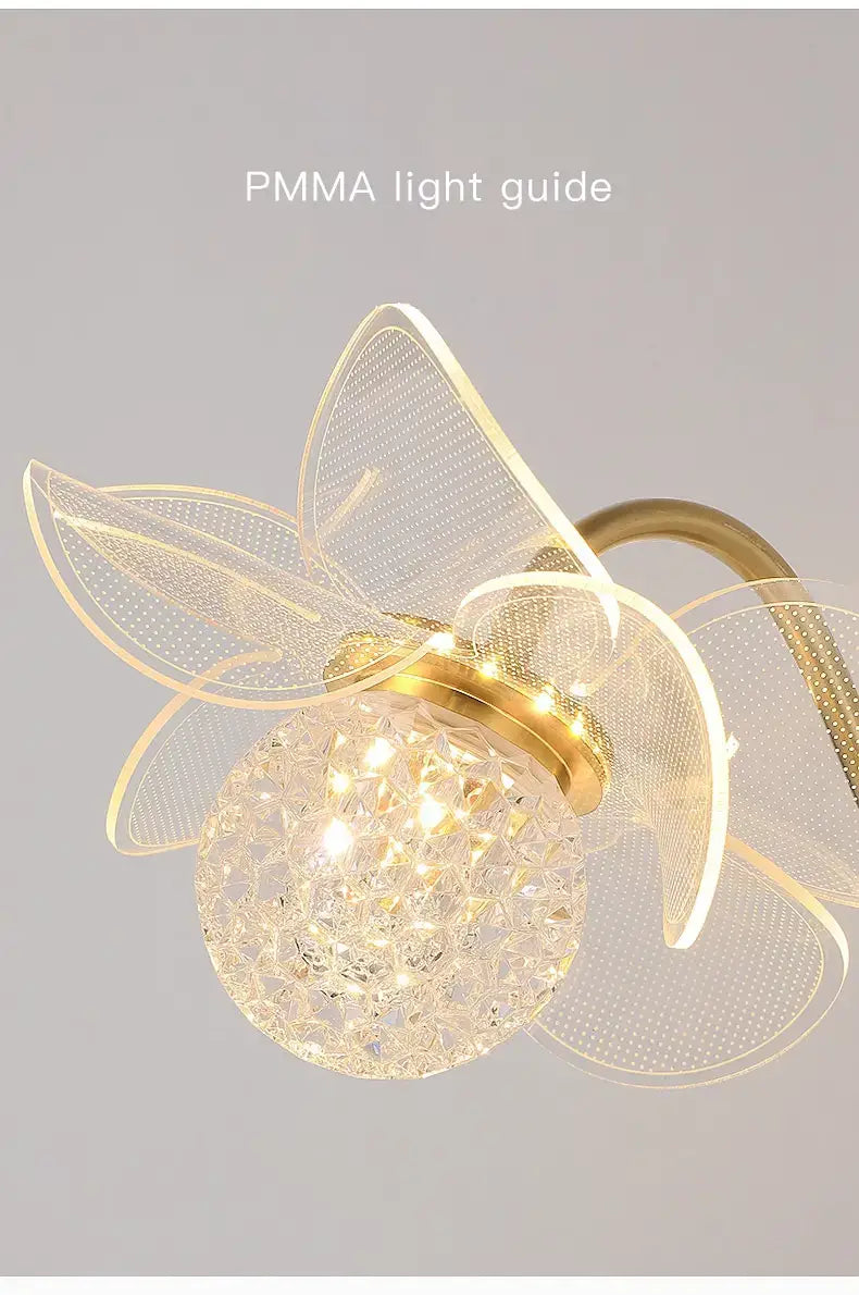 A creative floral decorative gold led wall lamp featuring a delicate flower-shaped design with translucent pmma petals and a faceted crystal globe at its center.