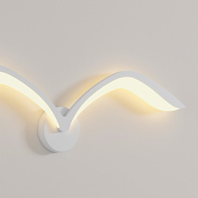 Modern white nordic avian style wall lamp shaped like a seagull with sleek design and warm led lighting for style indoor use.