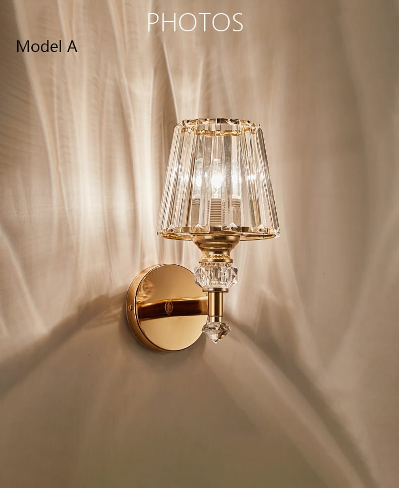 Modern minimalist gold wall lamp featuring a gold-toned wall sconce with a faceted crystal shade and decorative crystal accents designed for bedroom use.