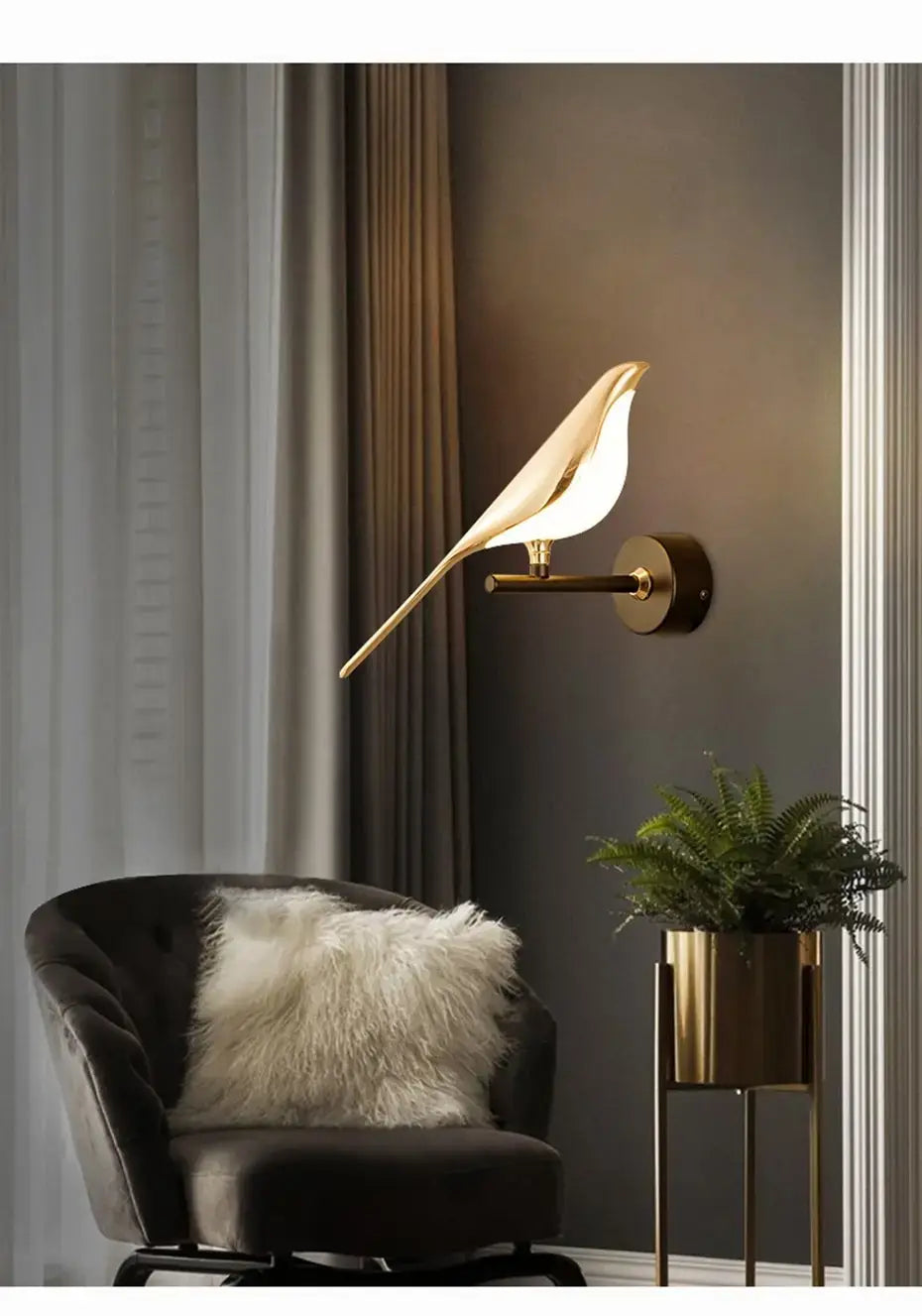 Gold-toned bird-shaped wall lamp with a sleek minimalist design and illuminated body featuring crystal accents for bedroom bedside wall lighting.