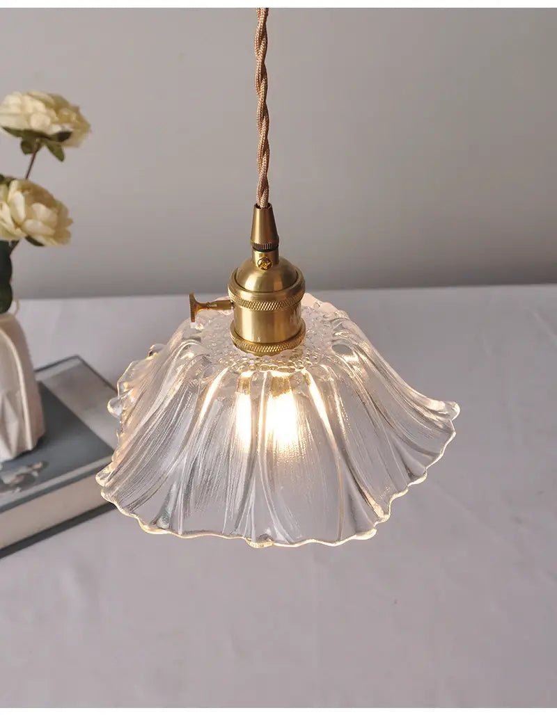 A delicate vintage pink green and white flower glass pendant light with fluted petal-like clear glass and brass hardware ideal for dining room home decor.