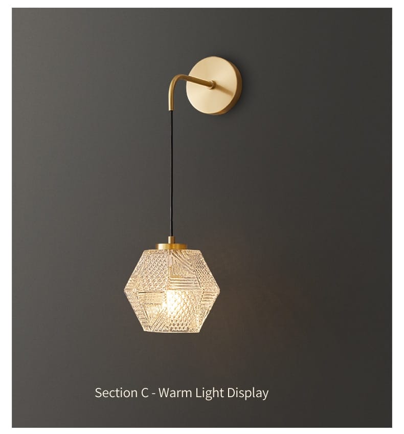 Gold-toned postmodern luxury led wall lamp featuring a hexagonal faceted crystal glass shade ideal for bedroom lighting.