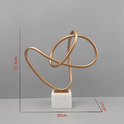 Escultura geométrica metálica DecorBites™ Gold Line sobre base de mármol para decoración del hogar
