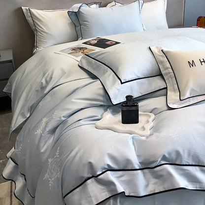 Juego de cama DecorBites™ de 4 piezas con diseño patchwork de satén jacquard y algodón egipcio.