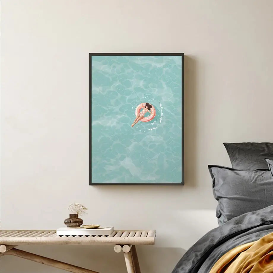 a framed DecorBites™ serene beach watercolor illustration featuring a woman floating on a pink inflatable ring in turquoise water, perfect as a swimming watercolor illustration art print.