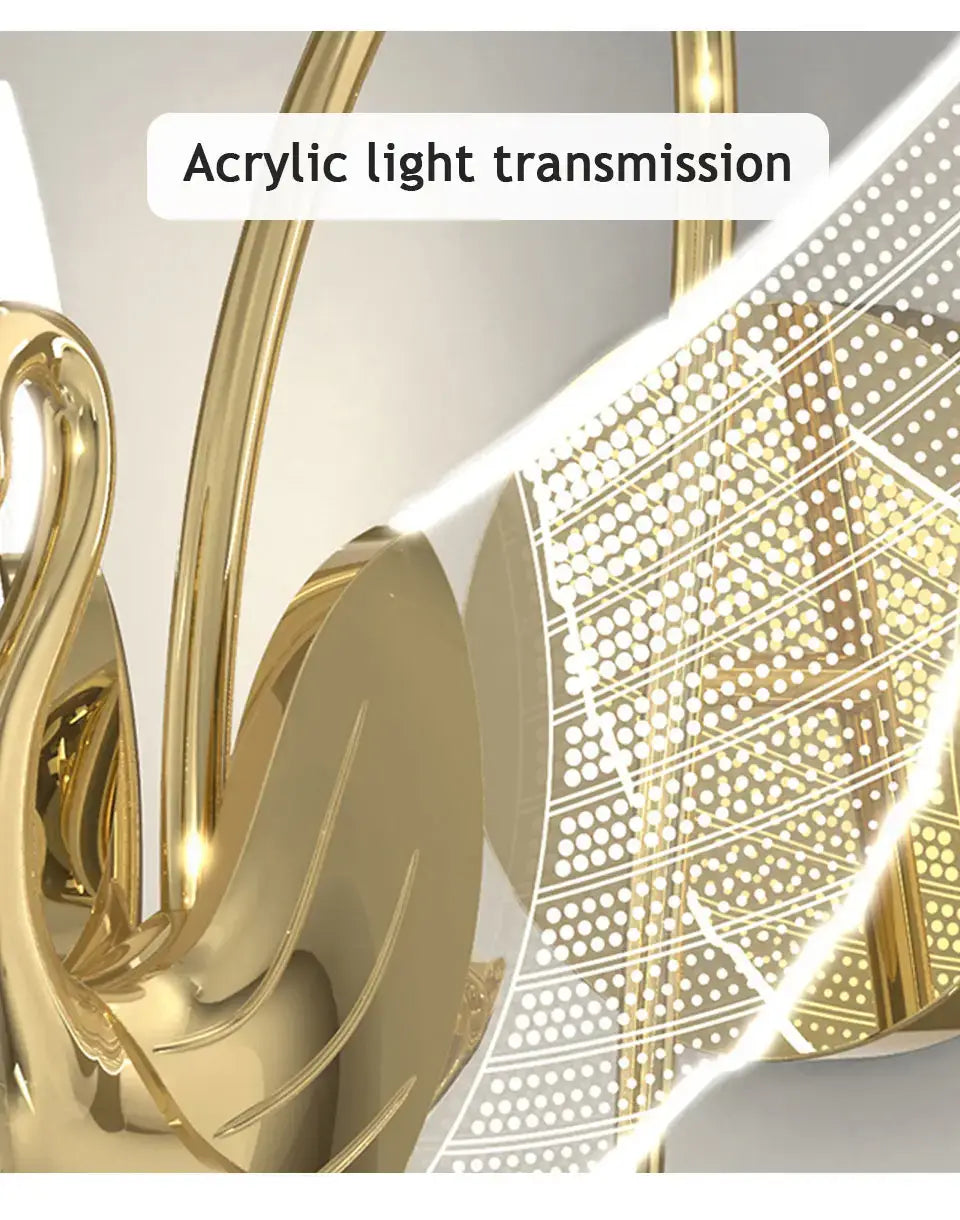 Art deco gold swan wall lamp with crystal featuring a golden acrylic chandelier design with intricate sculpted swan-like arms and a perforated light panel for bedroom bedside use.