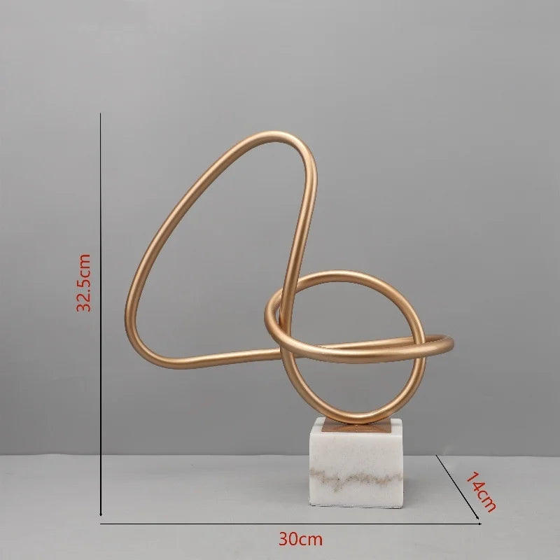 Escultura geométrica metálica DecorBites™ Gold Line sobre base de mármol para decoración del hogar
