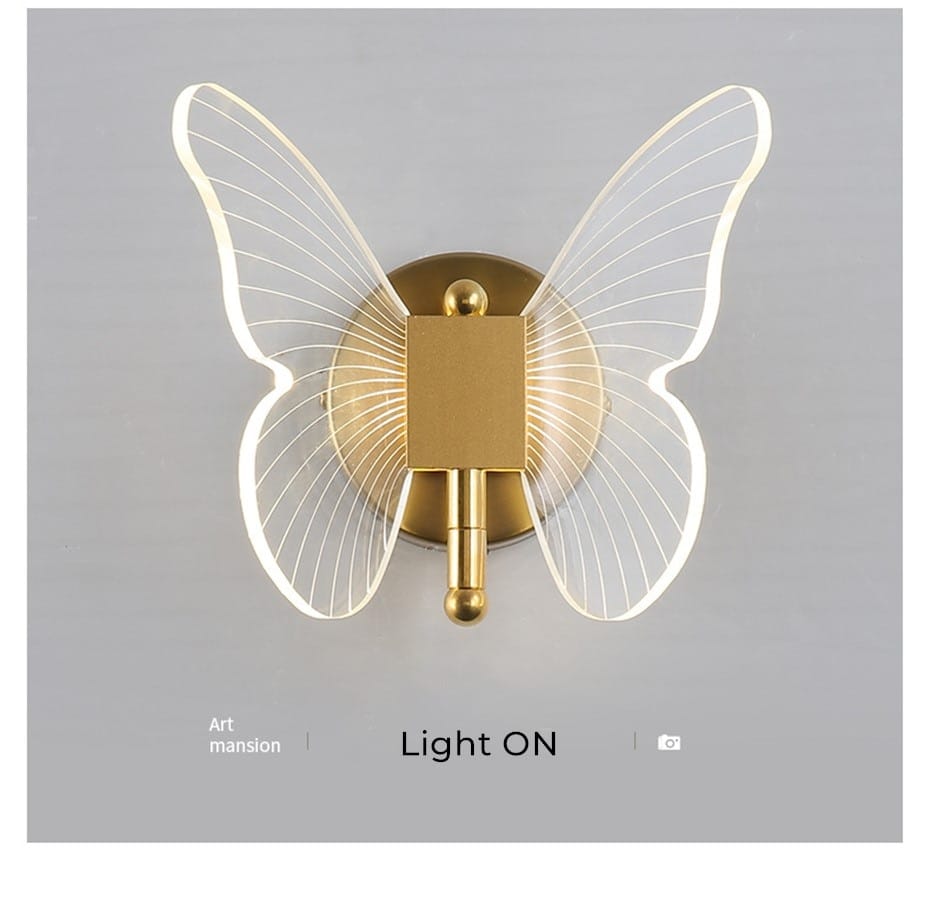 art deco gold-toned butterfly-shaped wall lamp with crystal and translucent illuminated wings designed for bedroom bedside wall lighting.