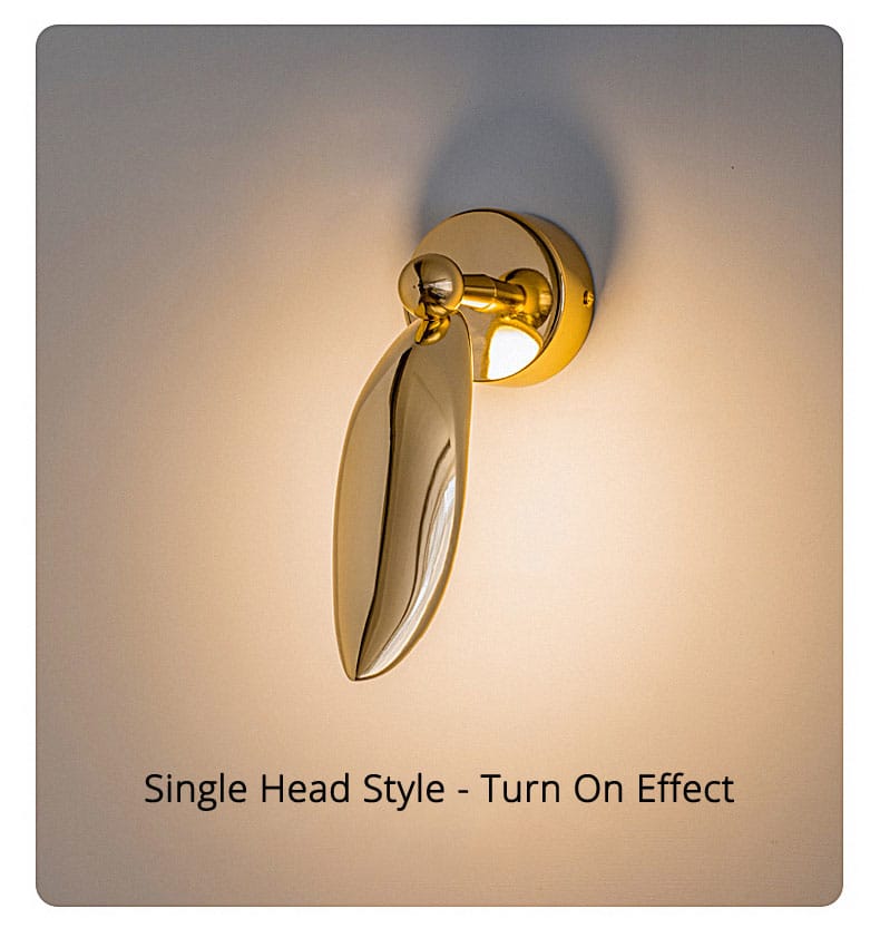 Luxury minimalist creative gold-finished wall sconce with a sleek leaf-shaped lamp head ideal for bedroom and living room use.