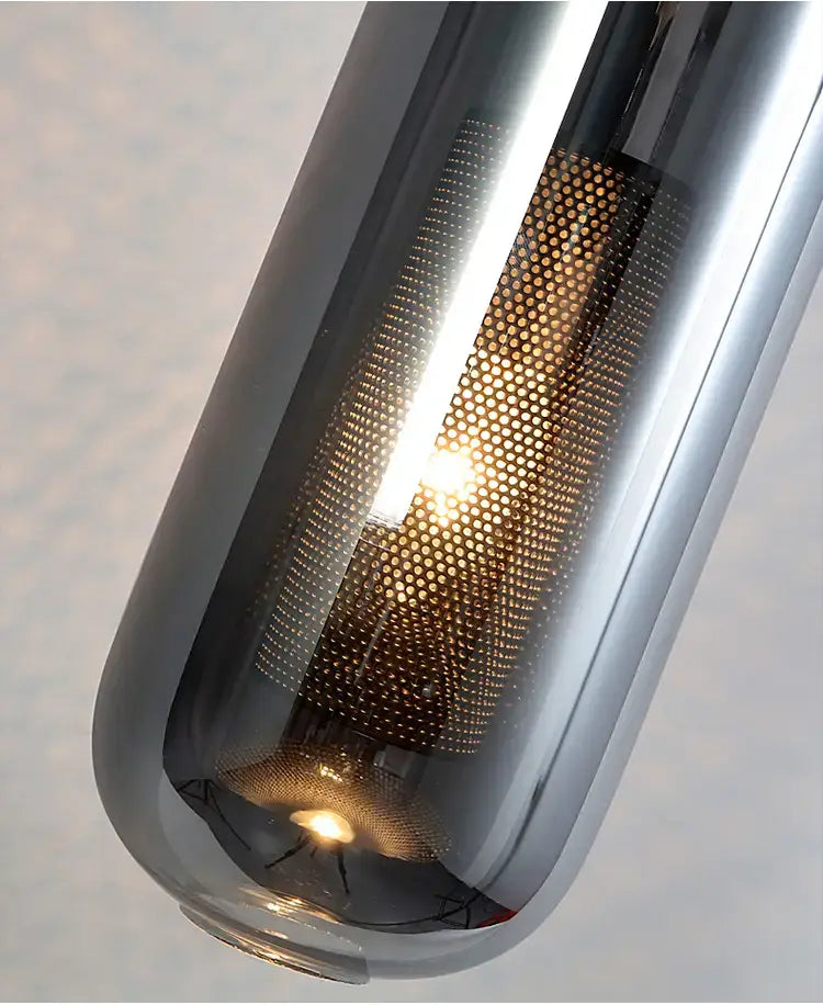 Modern chrome-finished pendant light featuring a perforated glass lampshade with a visible warm-toned bulb, ideal for nordic modern decor and modern decor glass wall lamps for the bedroom.
