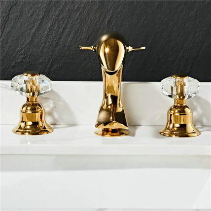 Grifo para lavabo DecorBites™ Gold: Grifo para lavabo de baño Dolphin de latón y níquel, 3 orificios de separación.