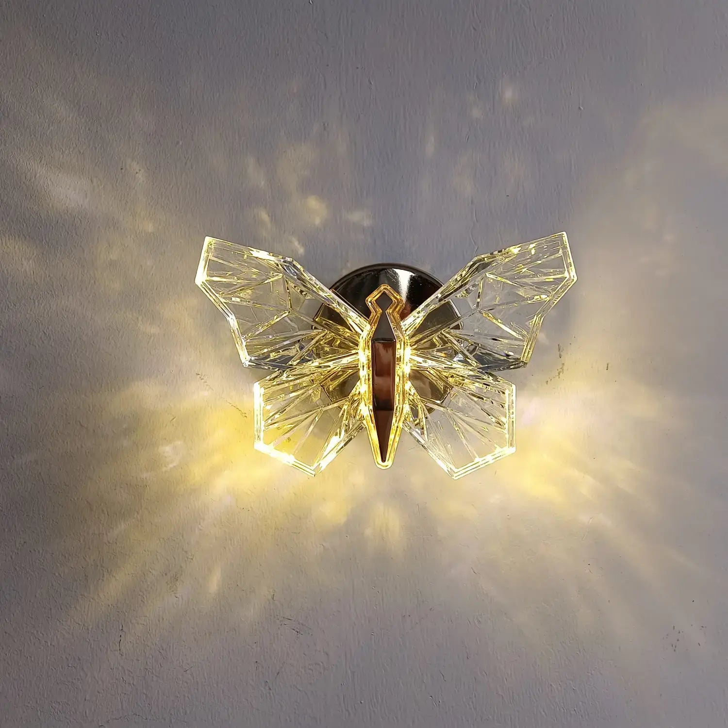 Luxury gold butterfly wall lamp featuring a crystal butterfly wall sconce with faceted wings and a gold-toned central body for elegant bedroom lighting.