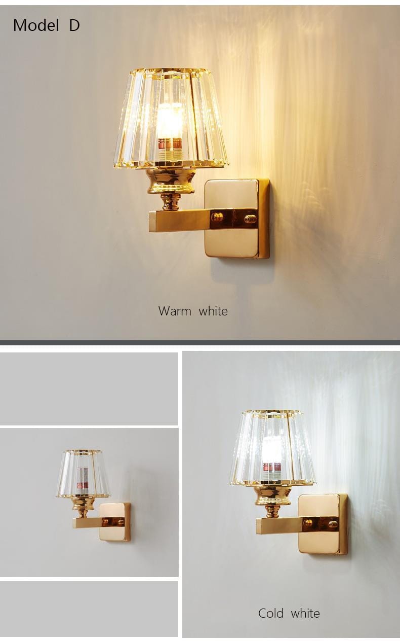 Modern minimalist wall lamp with gold finish and faceted crystal shade emitting warm white light for bedroom use.