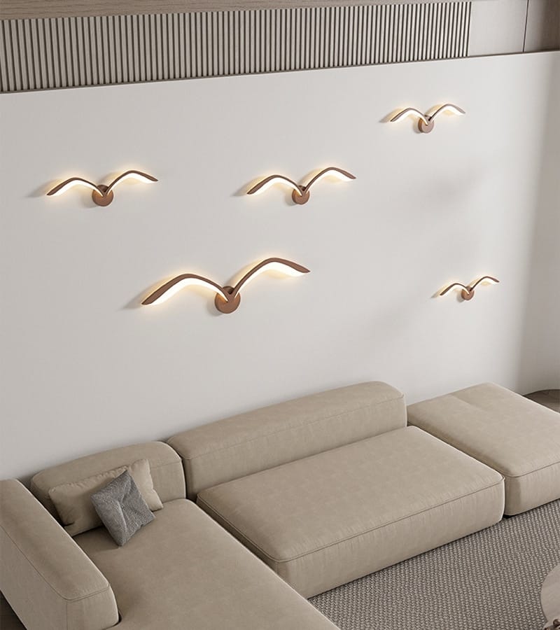 Five minimalist bronze-colored seagull-shaped wall lamp sconces with warm led lighting in nordic avian style for indoor bedroom use.