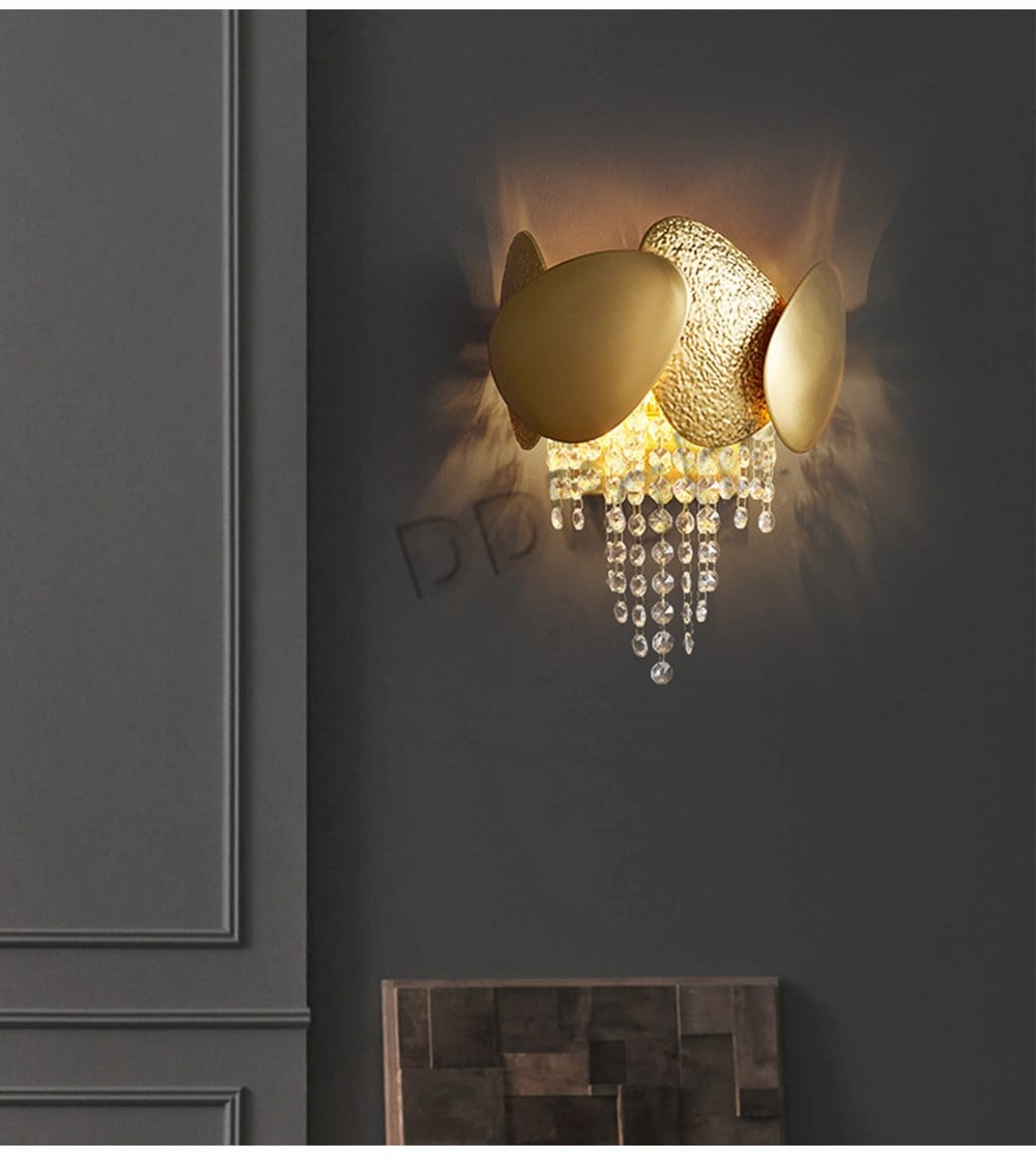 Luxury gold crystal led ceiling chandelier featuring a gold-toned wall sconce with a textured central element and dangling crystal beads for elegant living room lighting.