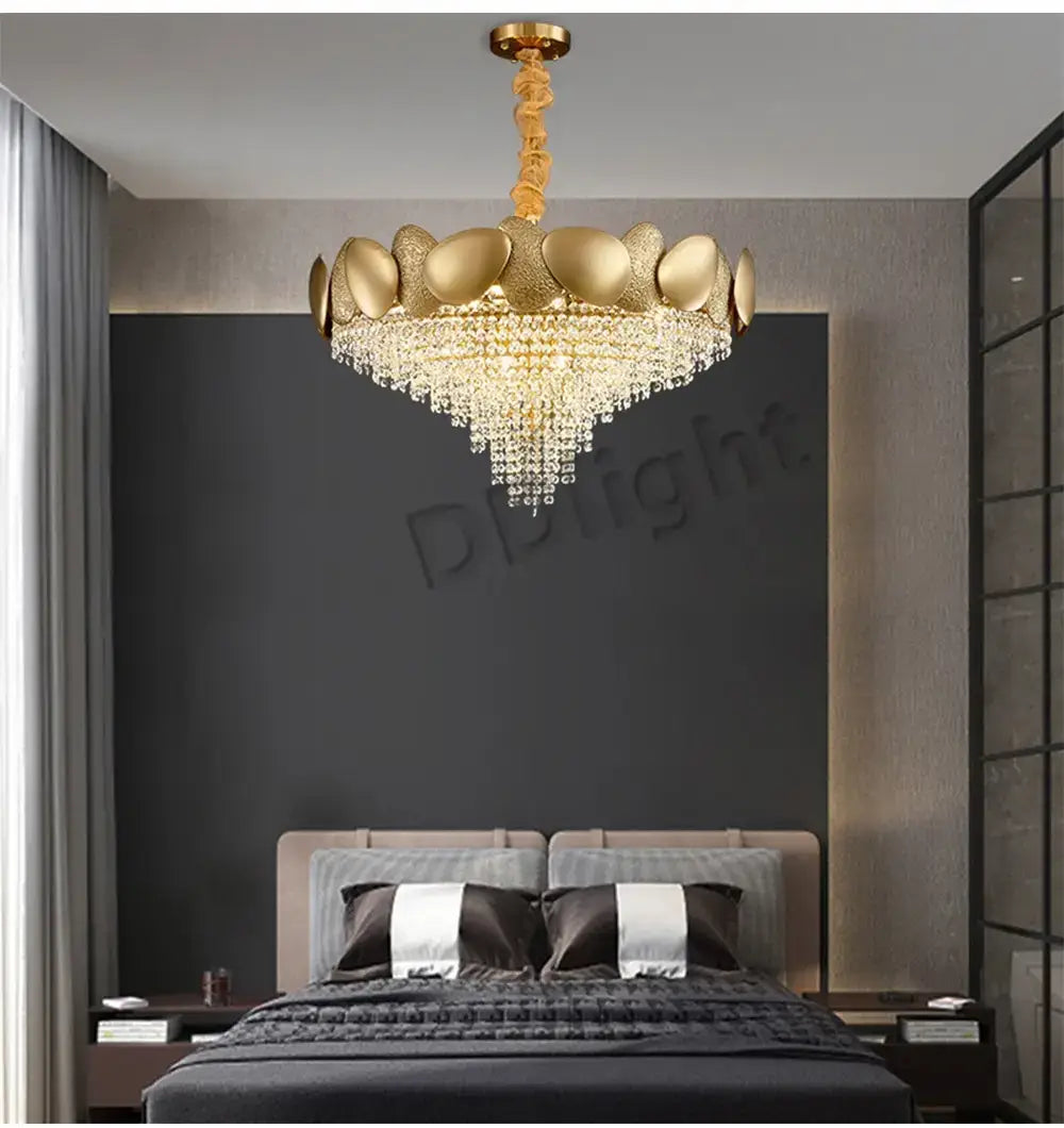 Luxury gold crystal led ceiling chandelier featuring a gold-toned leaf-like upper structure and cascading crystal droplets for living room use.