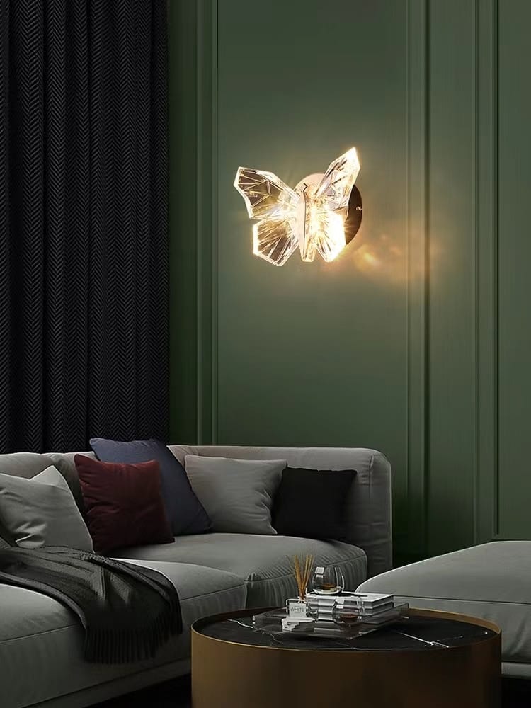 Luxury gold butterfly wall lamp featuring a translucent crystal butterfly design with a warm glowing light ideal for bedroom lighting.