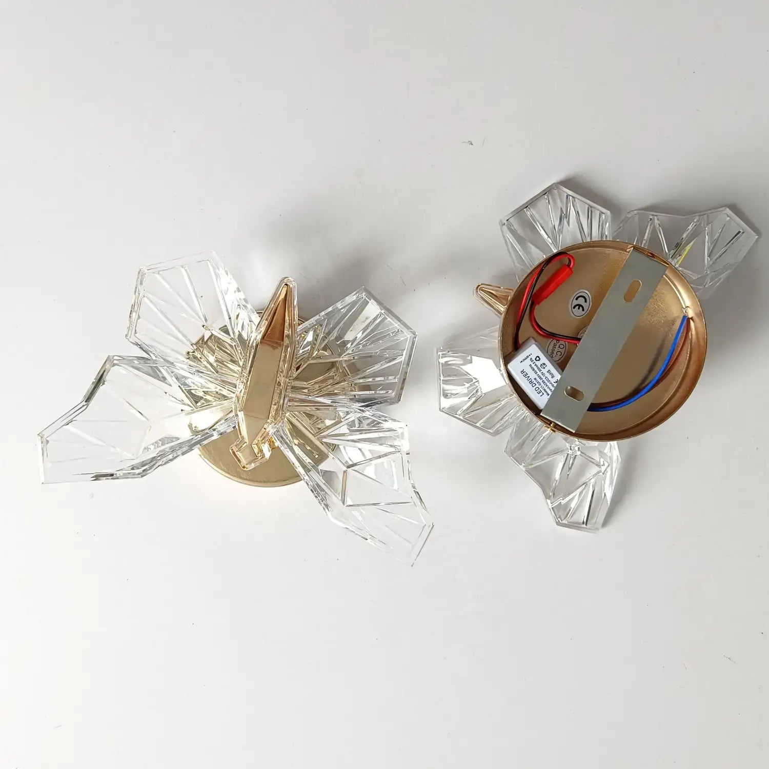 Luxury gold butterfly wall lamp featuring a clear crystal butterfly-shaped wall sconce with gold-toned metal accents for elegant bedroom lighting.