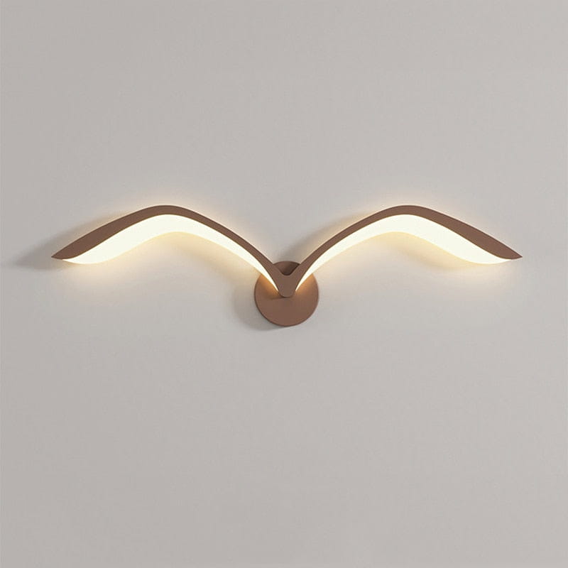 modern copper-toned wall lamp in nordic avian style featuring a bird shape with glowing led wings designed for style indoor use in bedrooms.