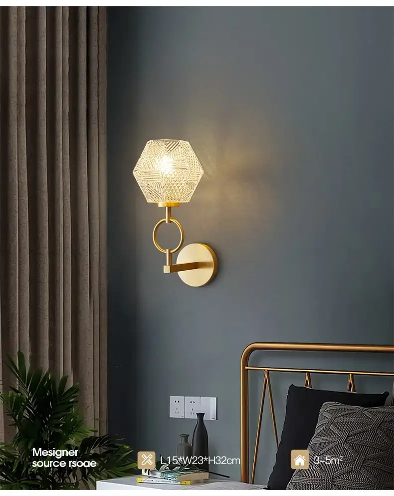 Gold-toned postmodern luxury led wall lamp with a hexagonal textured glass shade designed as a luxury led wall sconce for bedroom lighting.