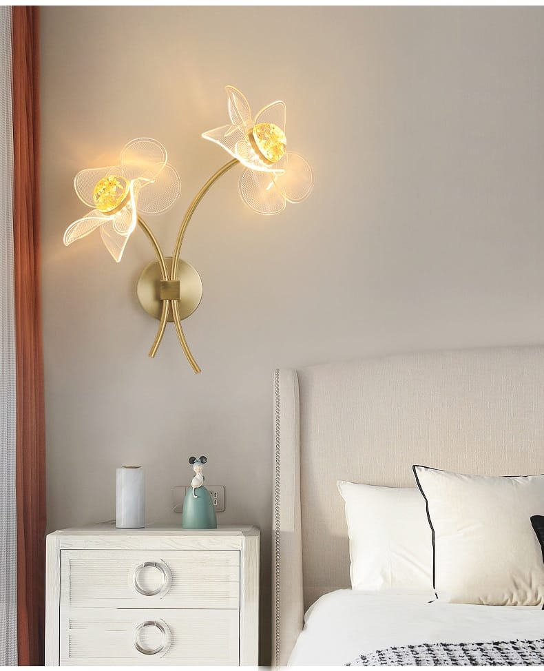 Creative floral decorative gold led wall lamp featuring a gold-toned sconce with two translucent flower designs and glowing yellow centers for elegant bedroom lighting.