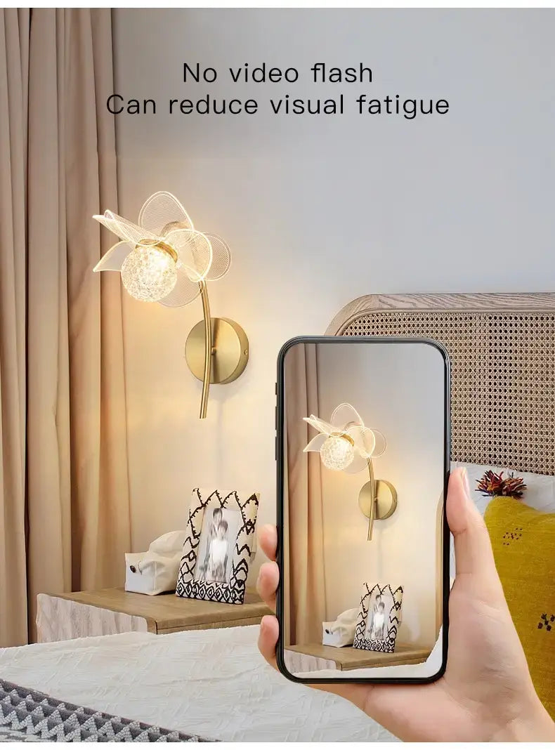 Creative floral decorative gold led wall lamp featuring a gold-toned wall sconce with a delicate translucent flower-shaped shade for bedroom use.